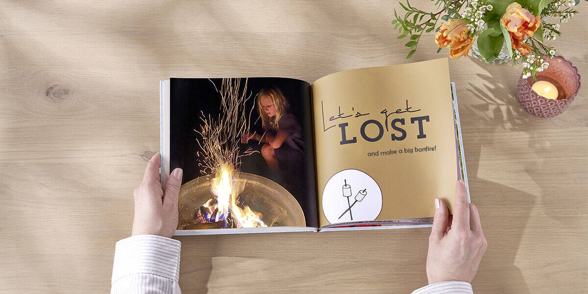 photo book open to page with building a campfire as a task to do together