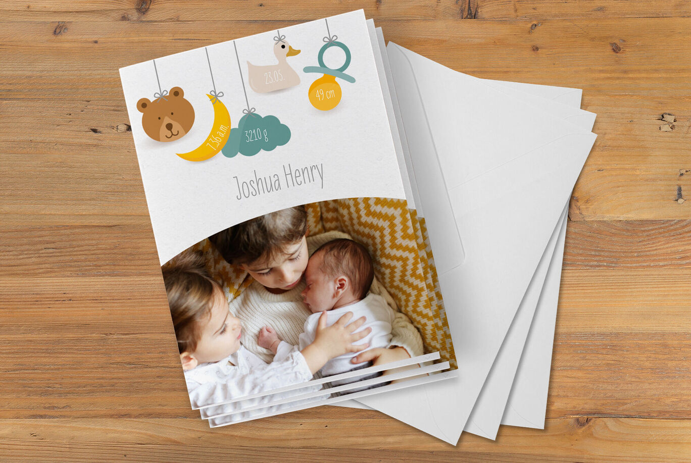 A lovingly designed photo book featuring two siblings embracing on a wooden table with empty pages in the background.