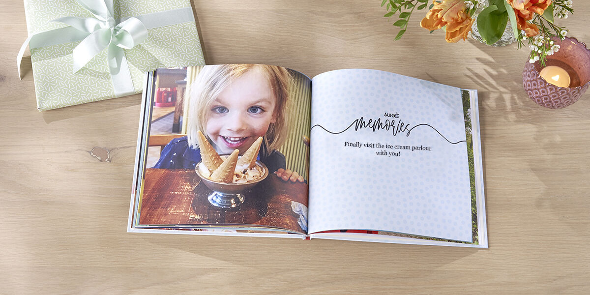 photo book showing child smiling over bowl of ice cream
